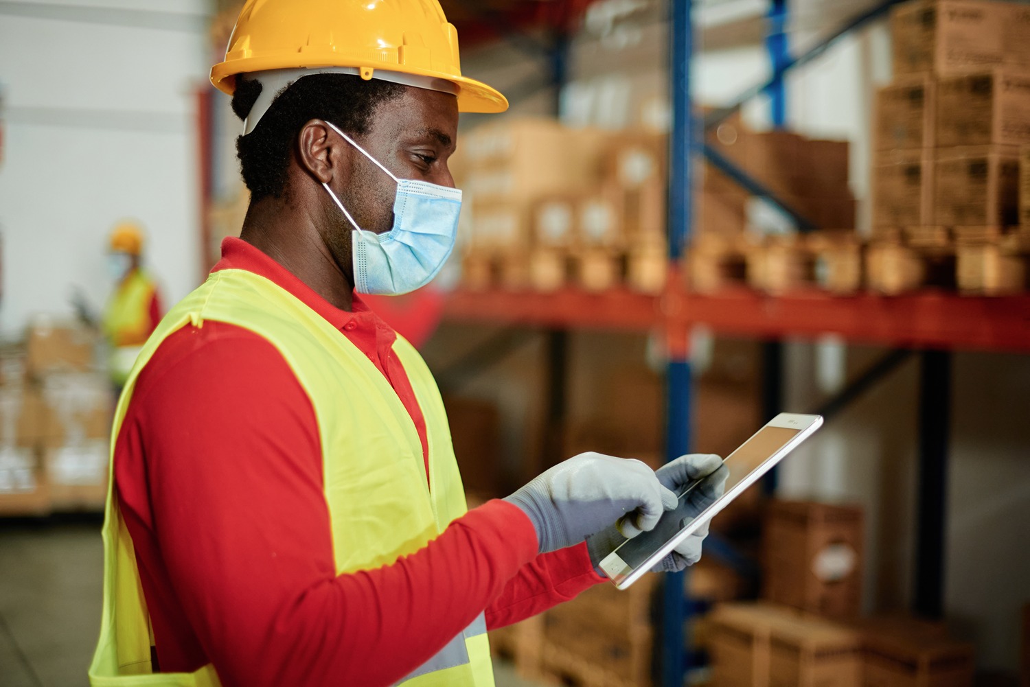 warehouse working checking their tablet